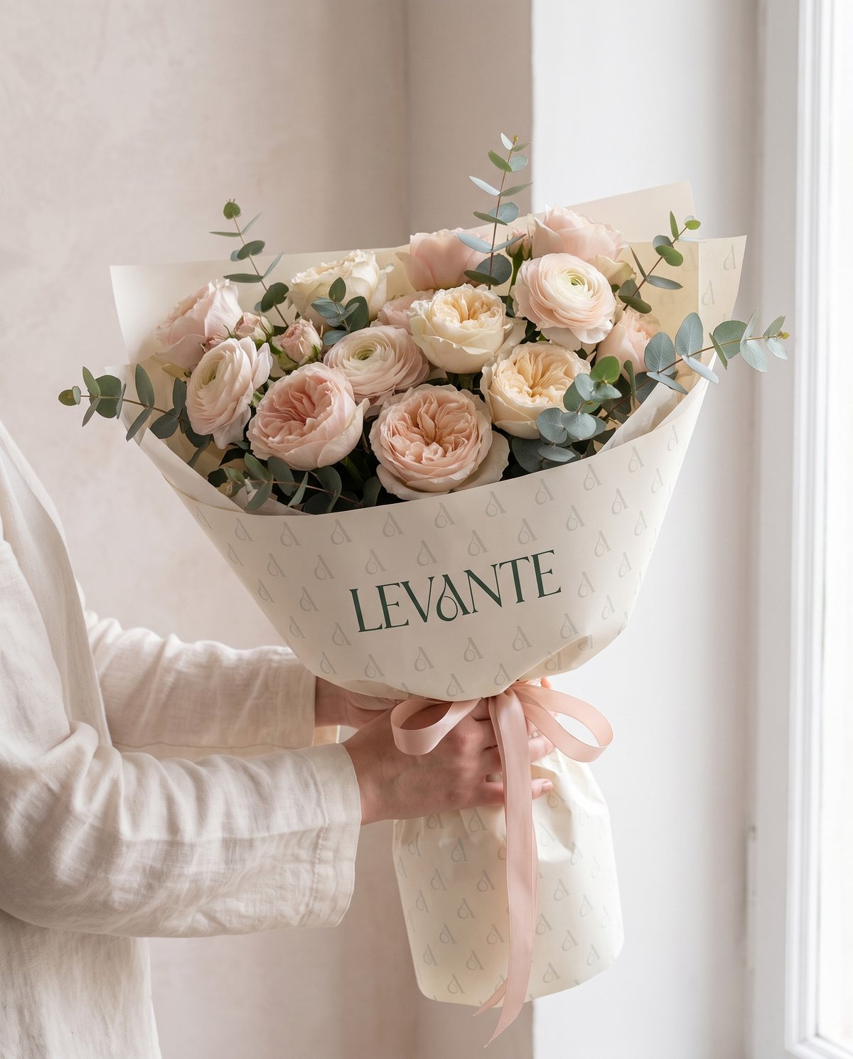 Bouquet wrapped in Levante monogram-patterned paper