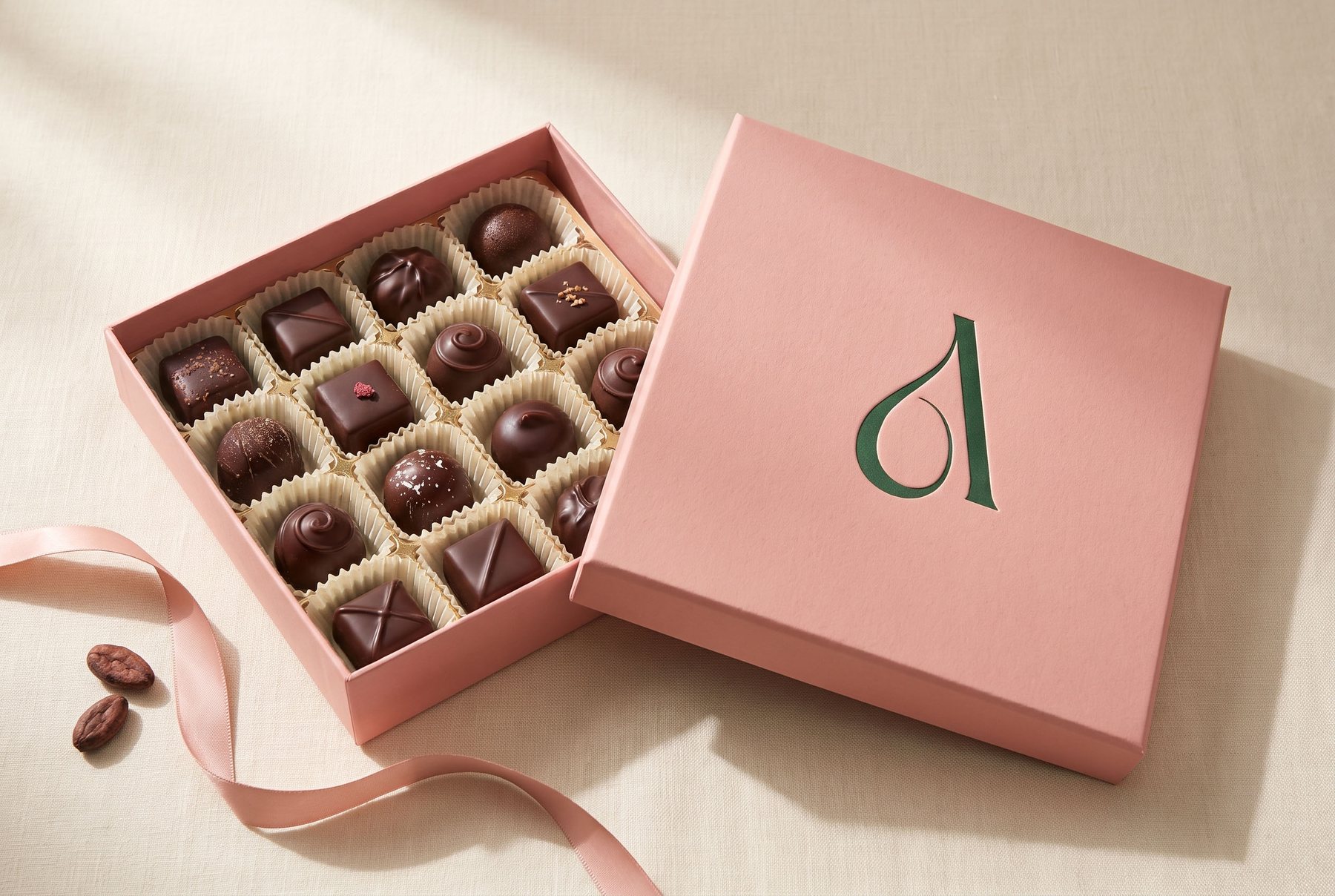 Levante blush chocolate box, open, with the monogram blind-debossed on the lid