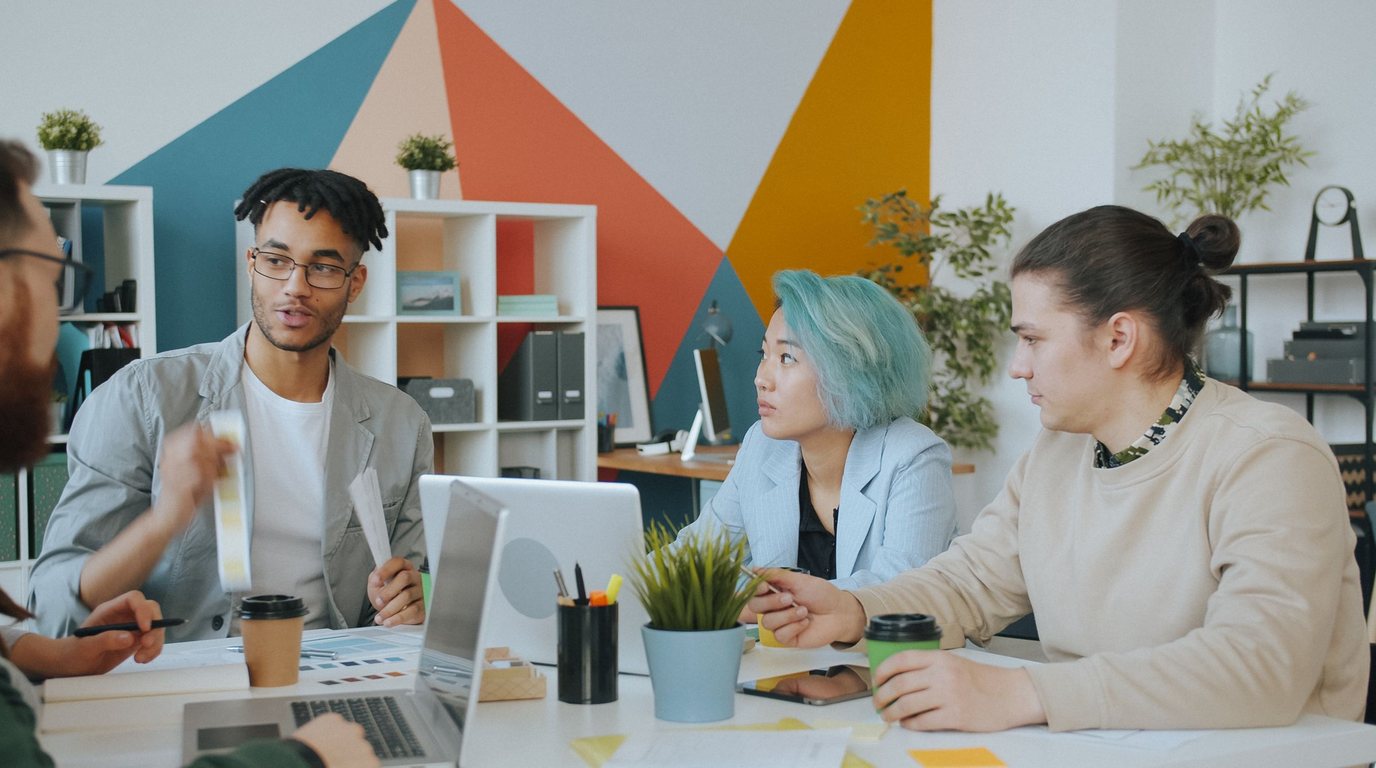 Stock photo: a creative team working together at a shared table in a bright studio