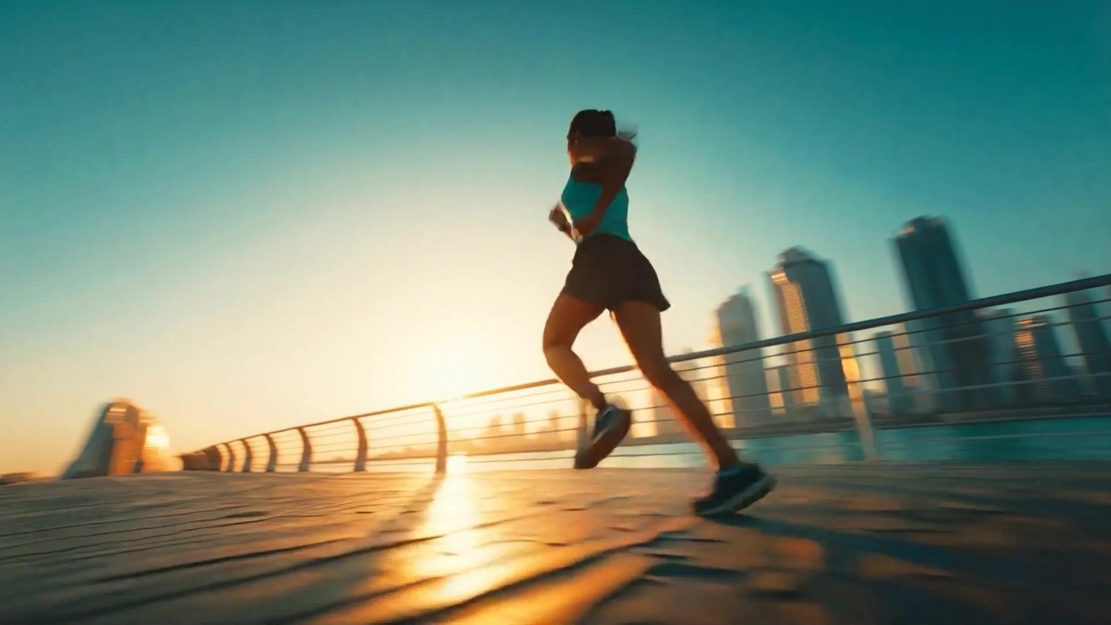 A frame from one of our AI ad films: a runner on a seafront promenade at sunrise
