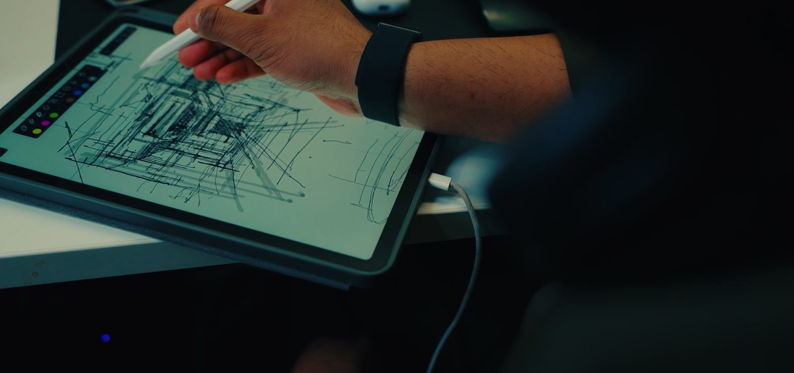 A hand sketching on a tablet, a frame from our LWK + Partners film