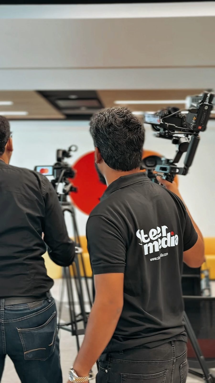 A Steer Media operator with a gimbal camera at a corporate event