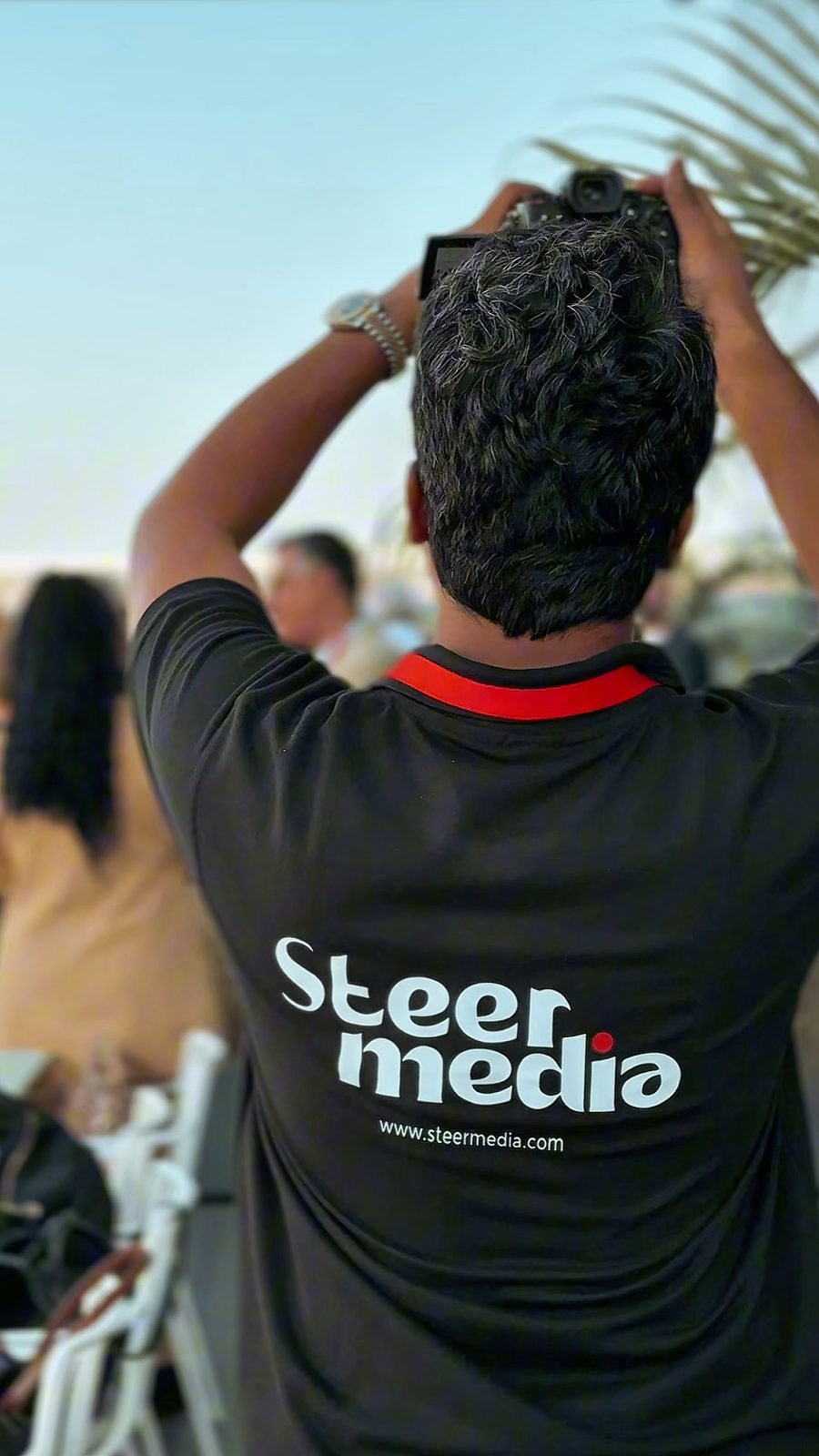 A Steer Media photographer shooting from behind at a UAE event
