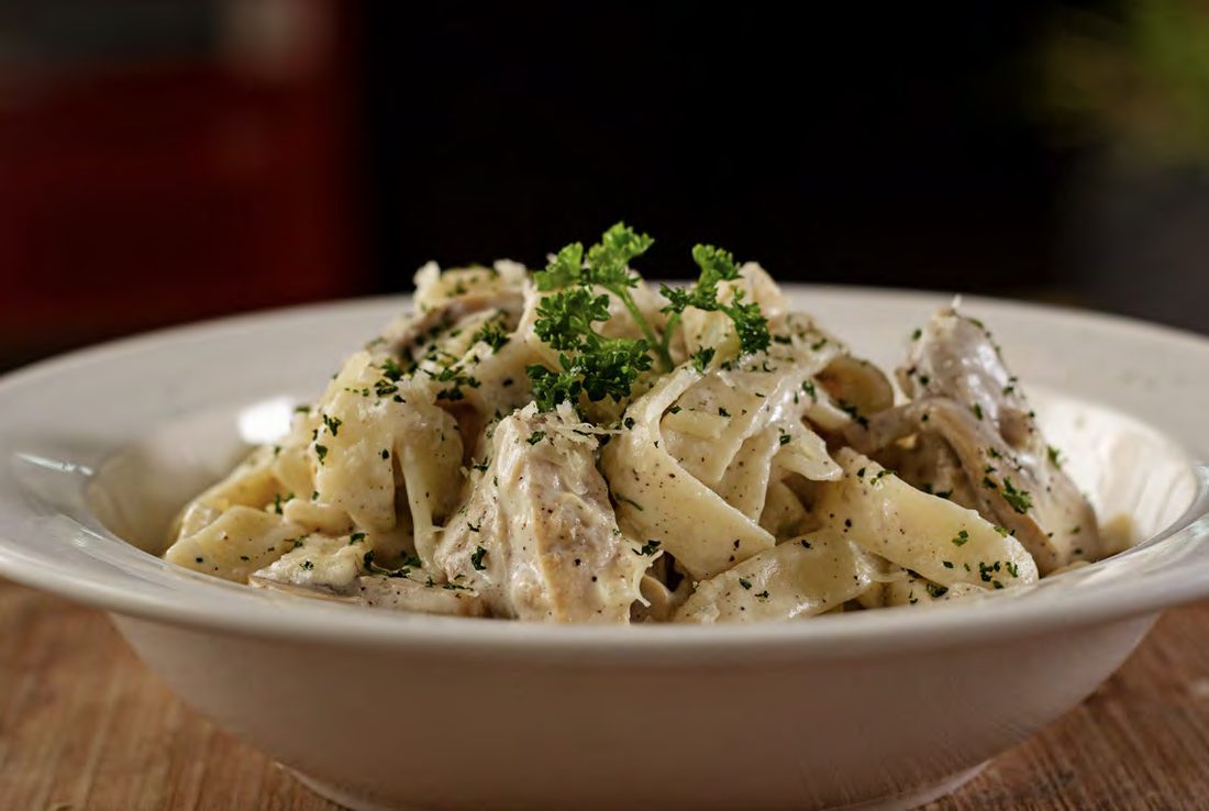 A bowl of creamy pasta with herbs